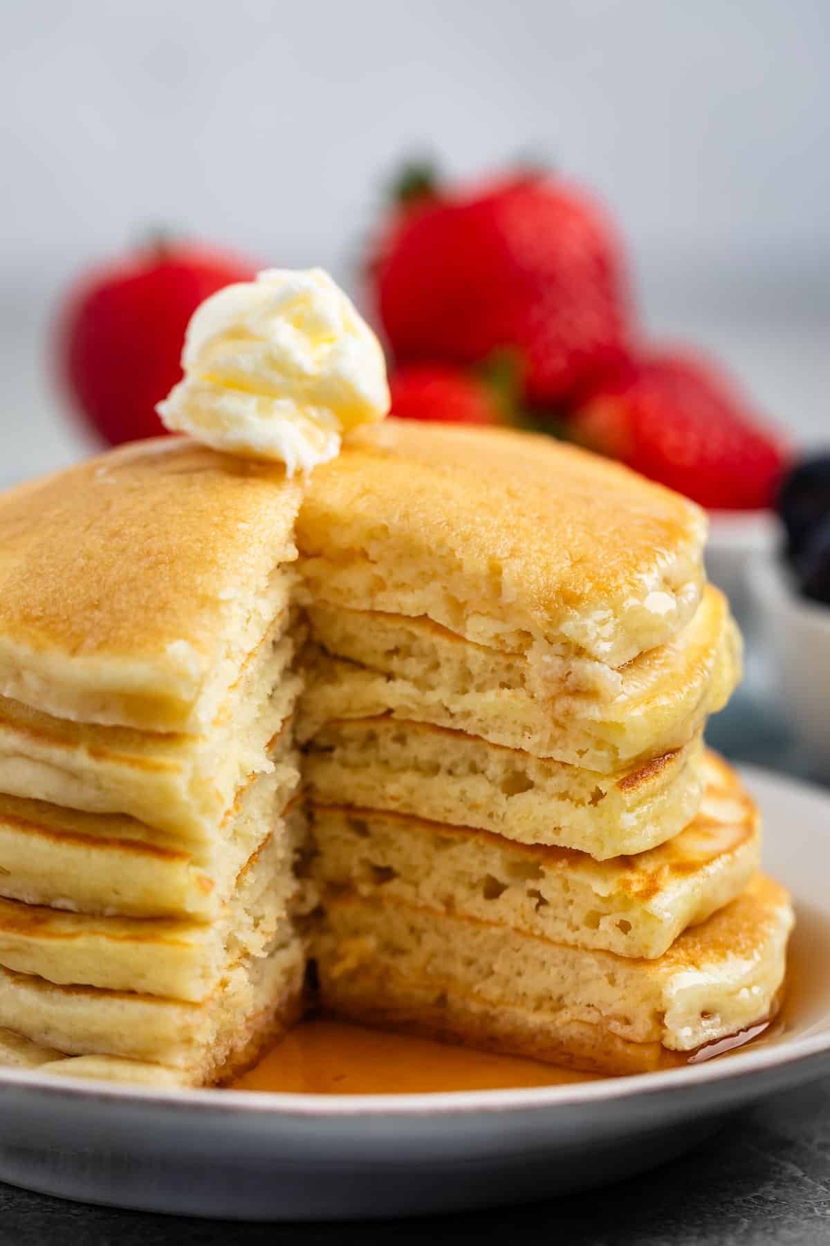 a stack of pancakes with syrup and butter on top.