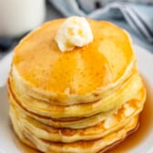 a stack of pancakes with syrup and butter on top.