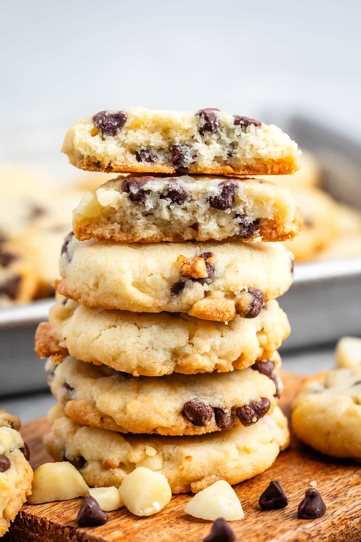 stacked cookies with chocolate chips baked into the cookie on a cutting board.