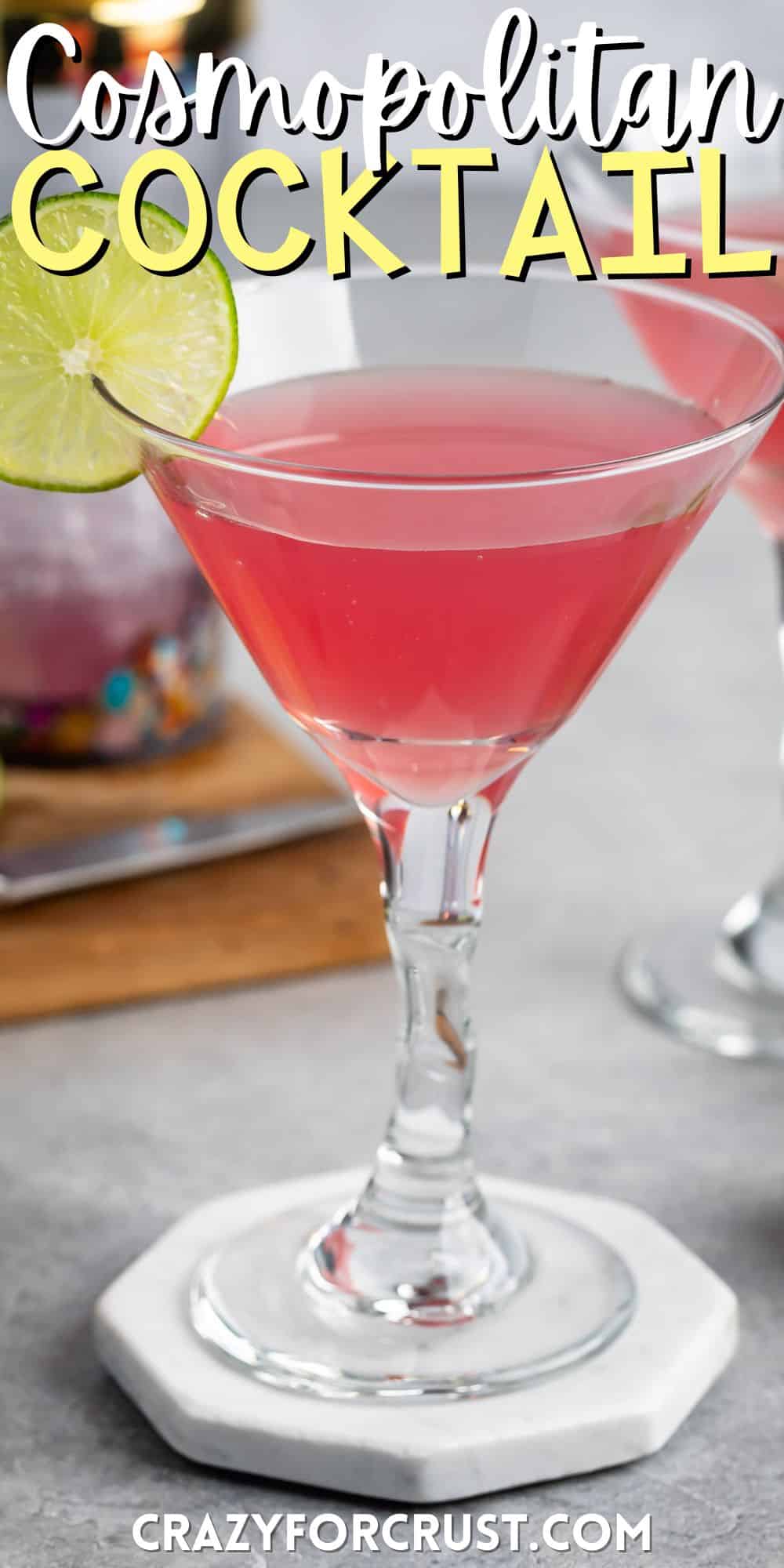 pink drink in a clear glass with a sliced lime on the edge with words on the image.