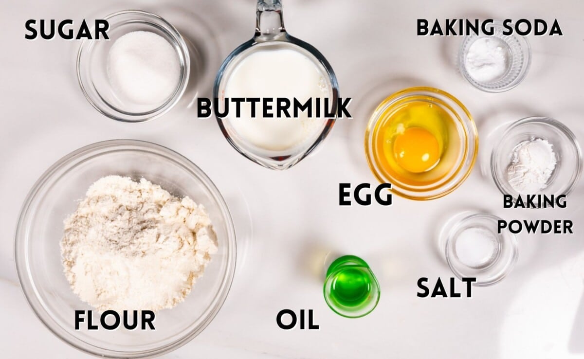 ingredients in fluffy pancakes laid out on a marble countertop.