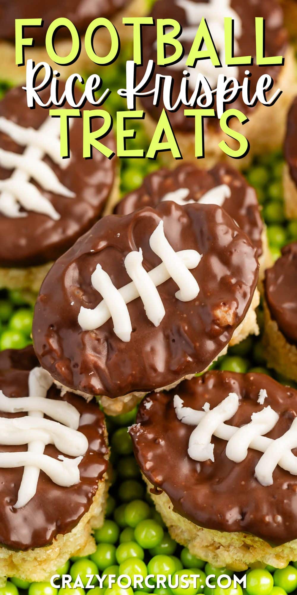 mini Rice Krispie treats in the shape on footballs with brown and white frosting on top to resembles a football on a field with words on the image.