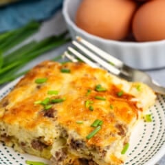 egg casserole with sausage baked in on a white plate.