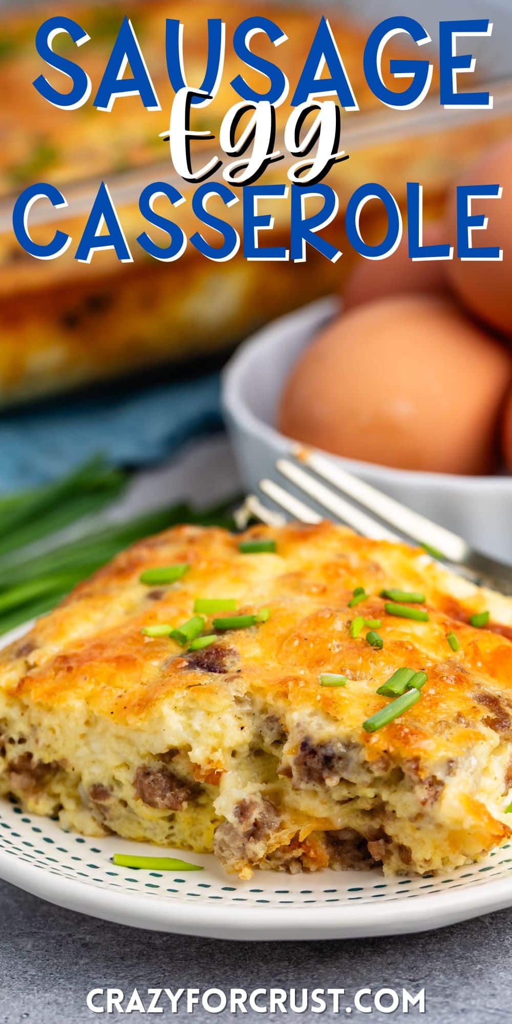 egg casserole with sausage baked in on a white plate with words on the image.