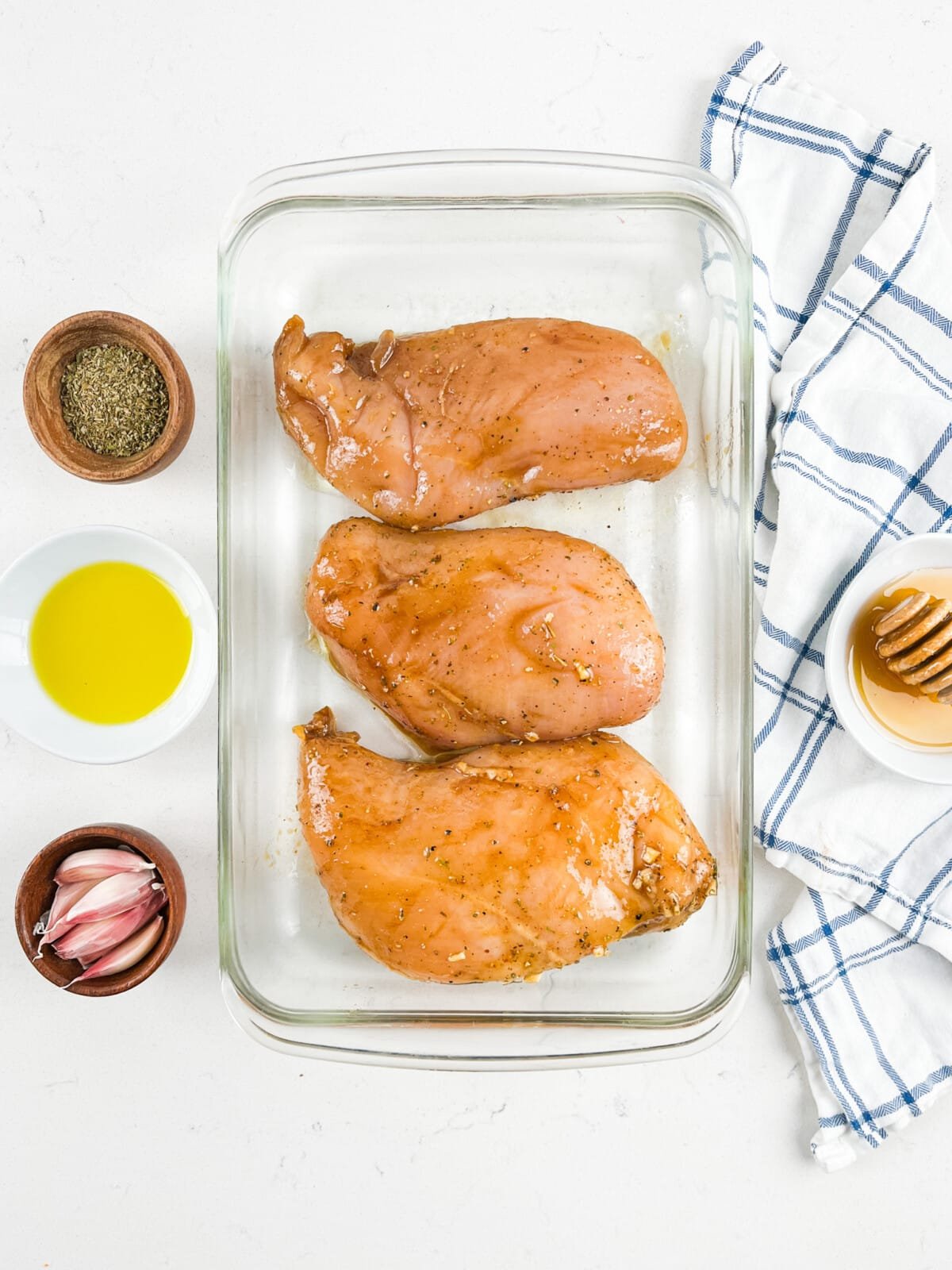 marinated chicken breasts in glass pan.