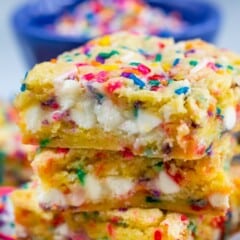 stacked funfetti bars with white chocolate chips and colorful sprinkles baked in.