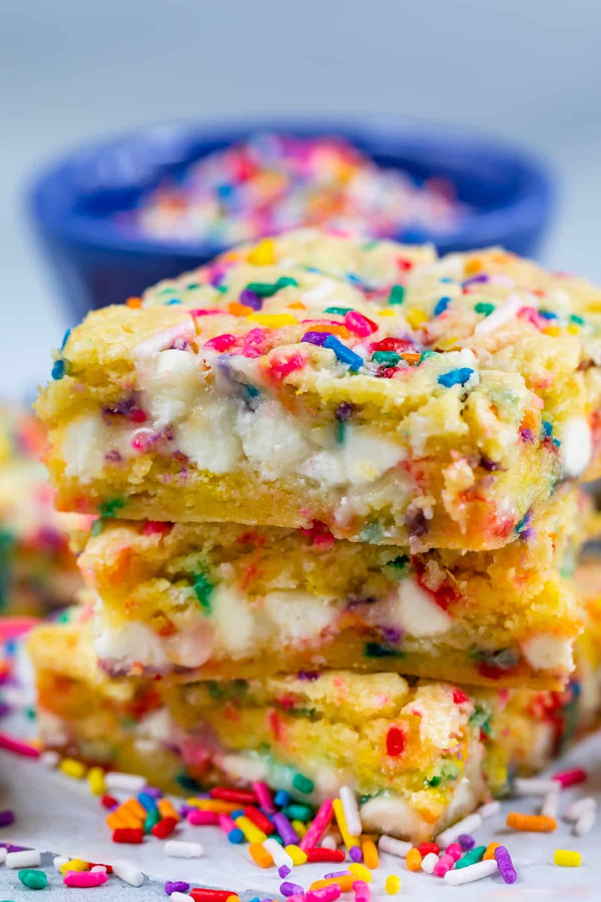 stacked funfetti bars with white chocolate chips and colorful sprinkles baked in.
