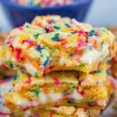 stacked funfetti bars with white chocolate chips and colorful sprinkles baked in.