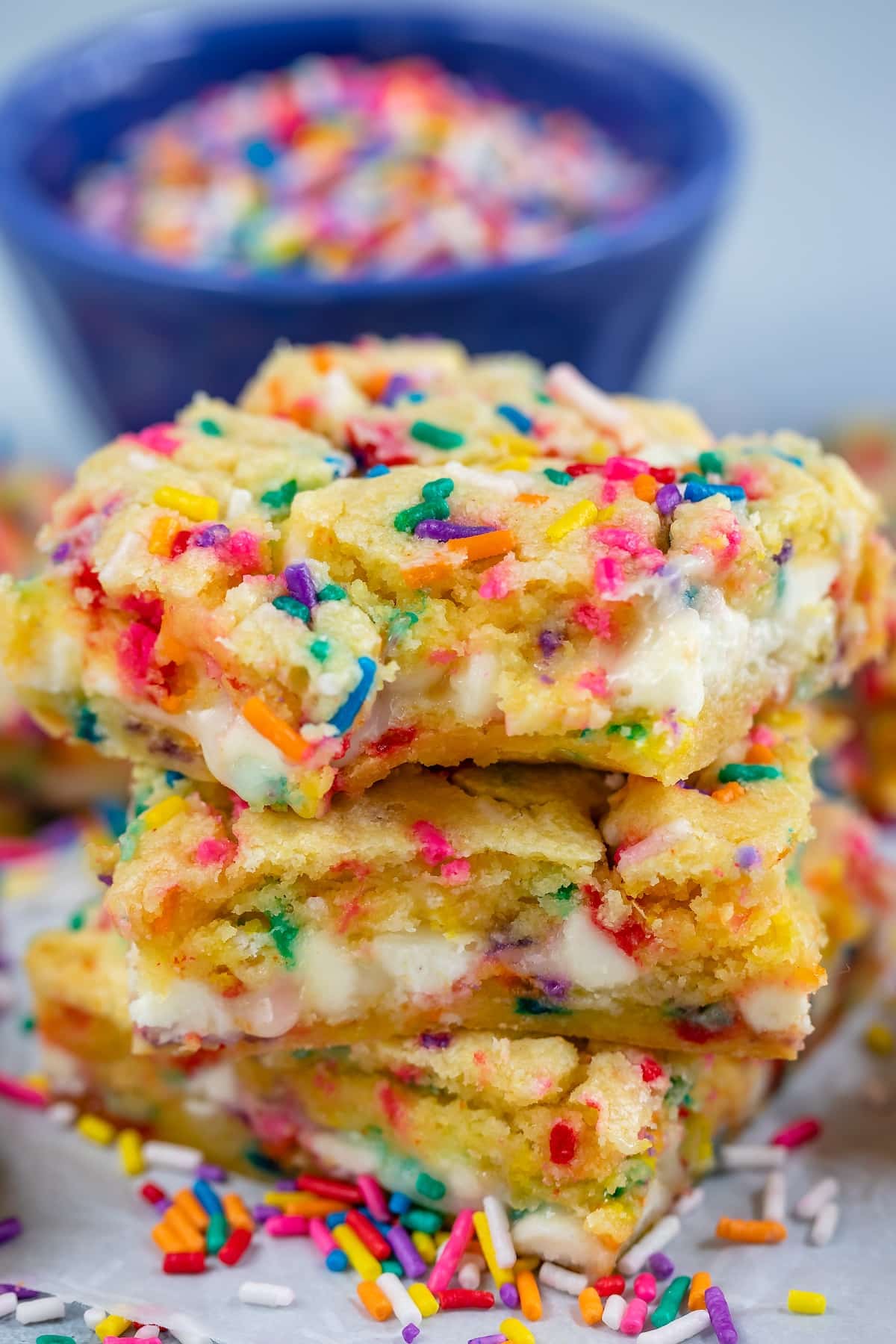 stacked funfetti bars with white chocolate chips and colorful sprinkles baked in.