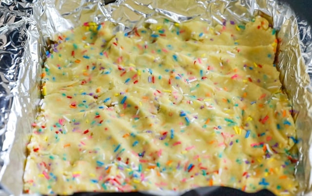 process shot of funfetti gooey bars being made.