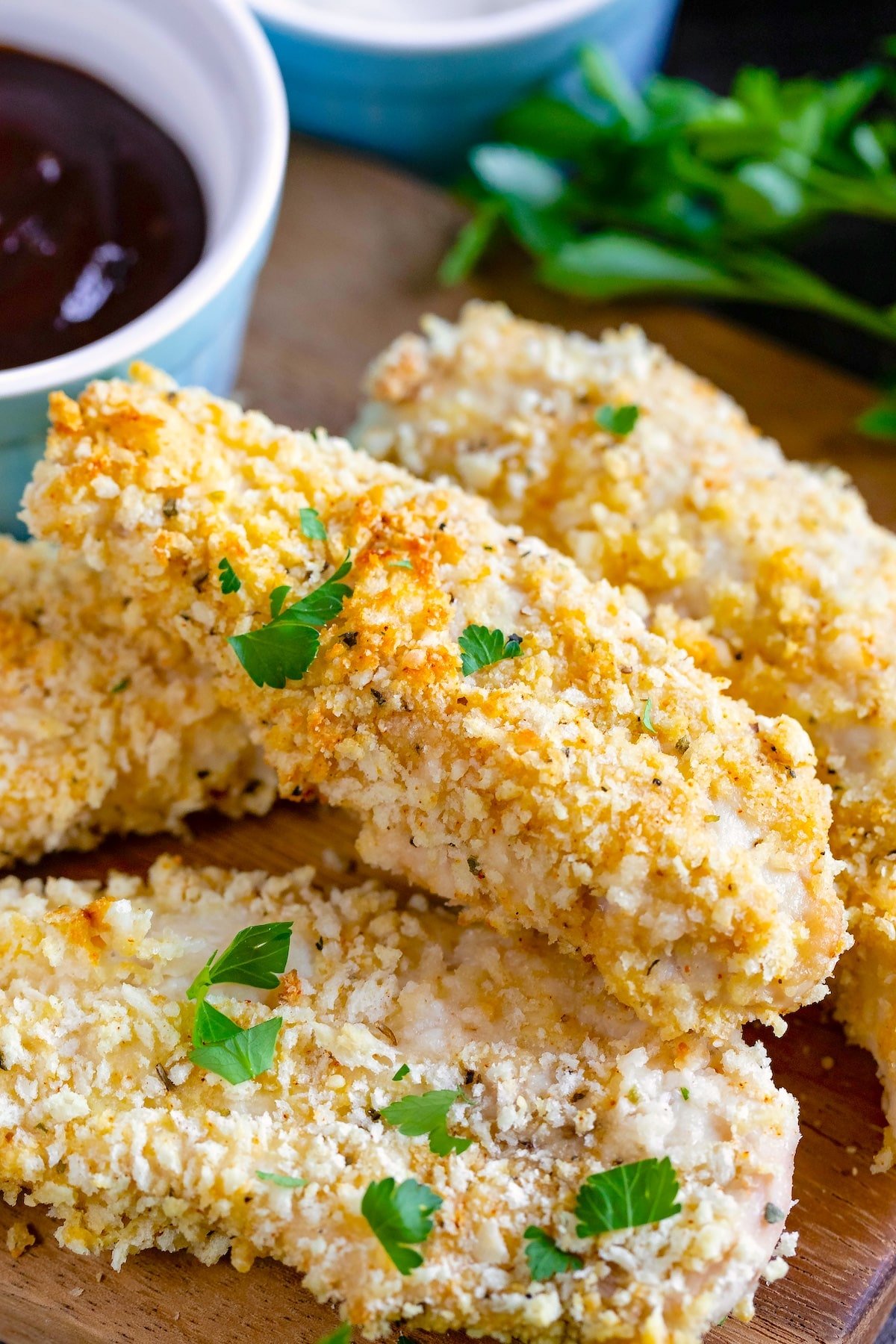 stacked chicken tenders with garnish on top.