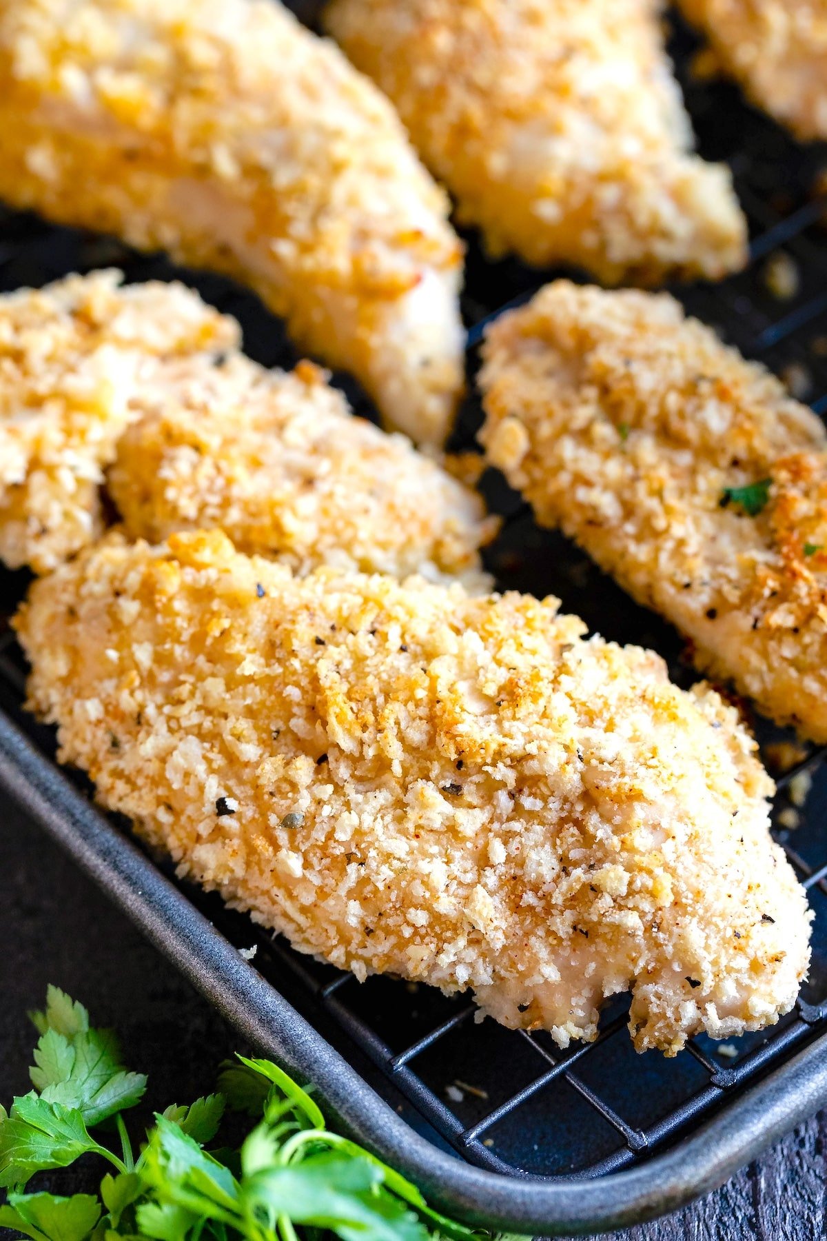 stacked chicken tenders with garnish on top.