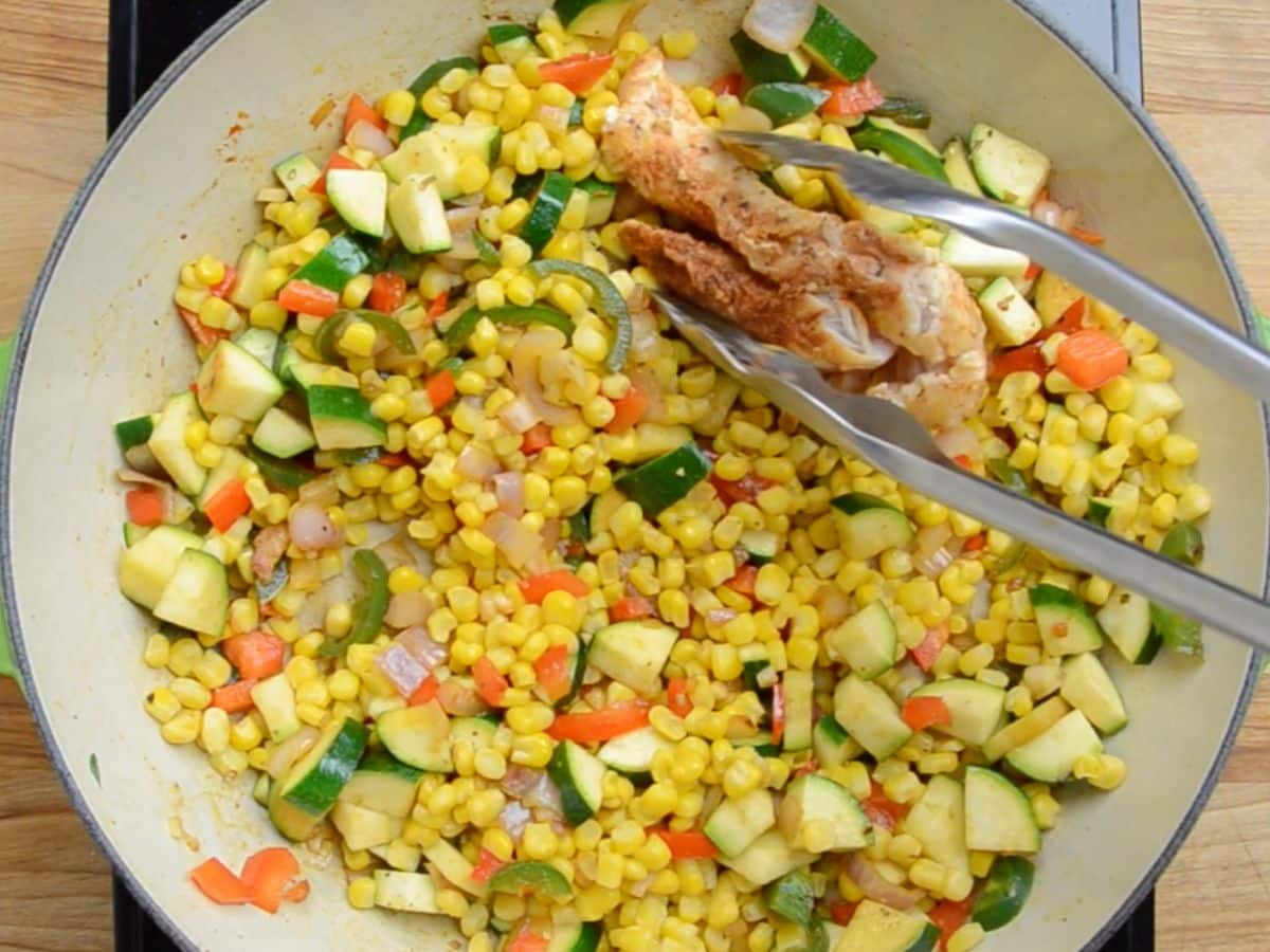 process shot of chicken and corn skillet being made.