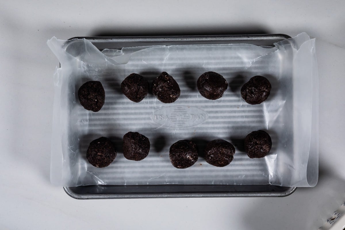 process shot of oreo truffle strawberries being made.