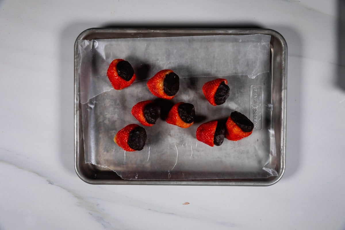 process shot of oreo truffle strawberries being made.