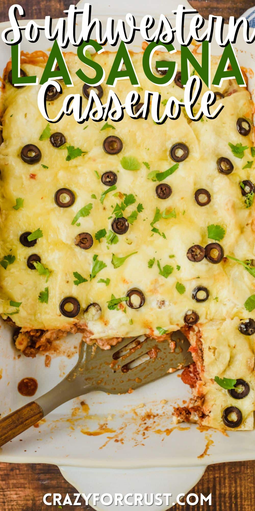casserole with cheese and black olives and garnish on top in a white casserole pan with words on the image.