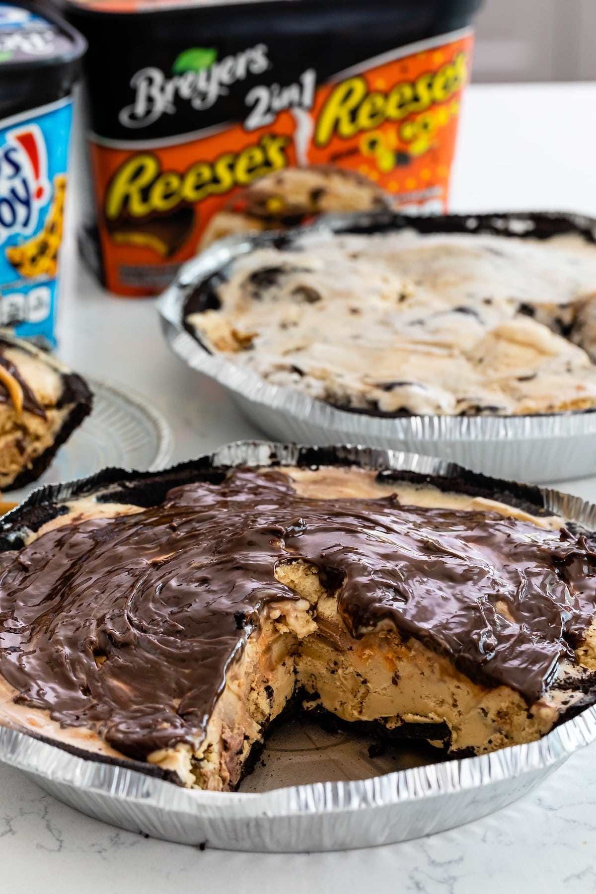 ice cream pie with chocolate on top in a metal pan.