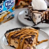 ice cream pie with chocolate on top on a grey plate.