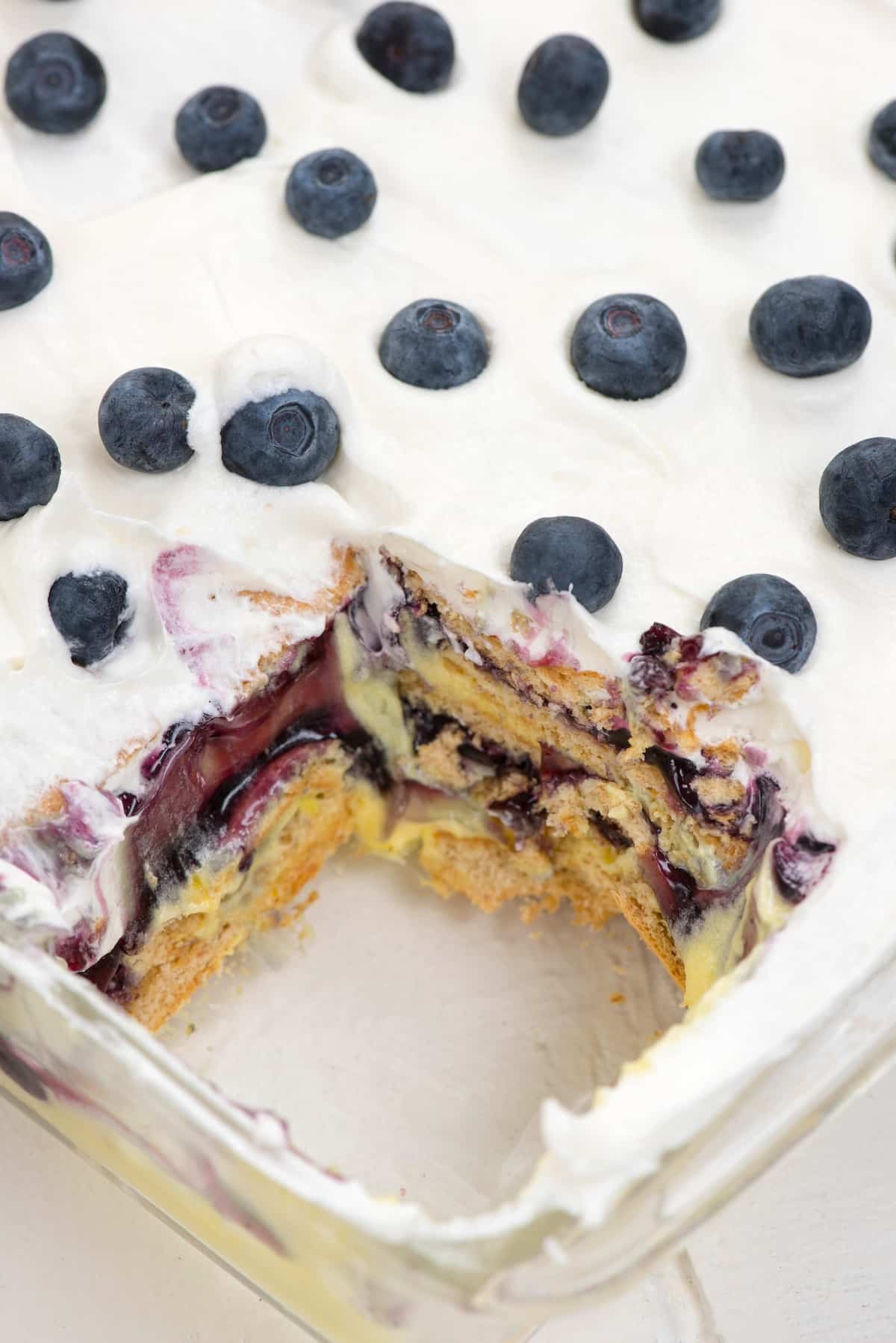 cake with blueberries and lemons on top.