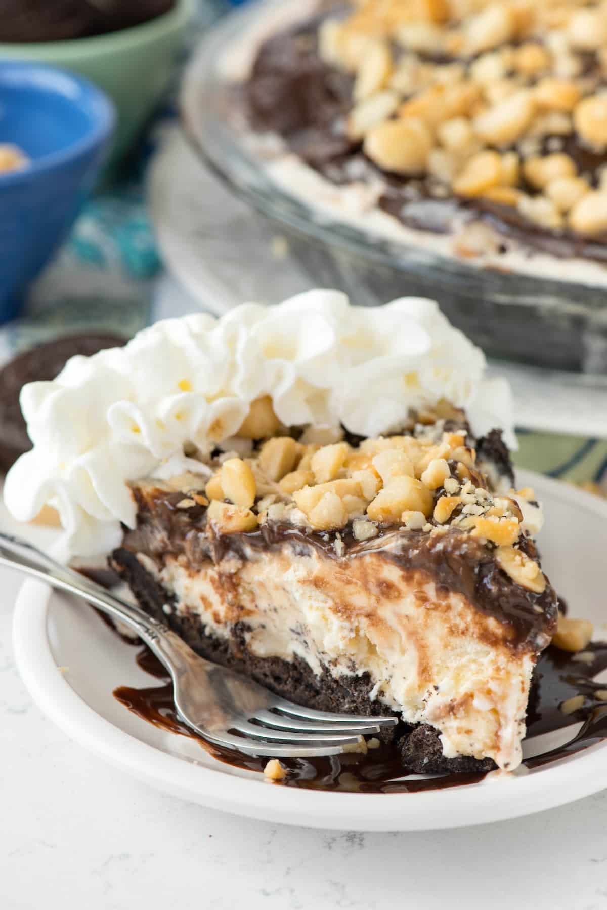 one slice of ice cream pie with chocolate sauce and macadamia nuts on top.