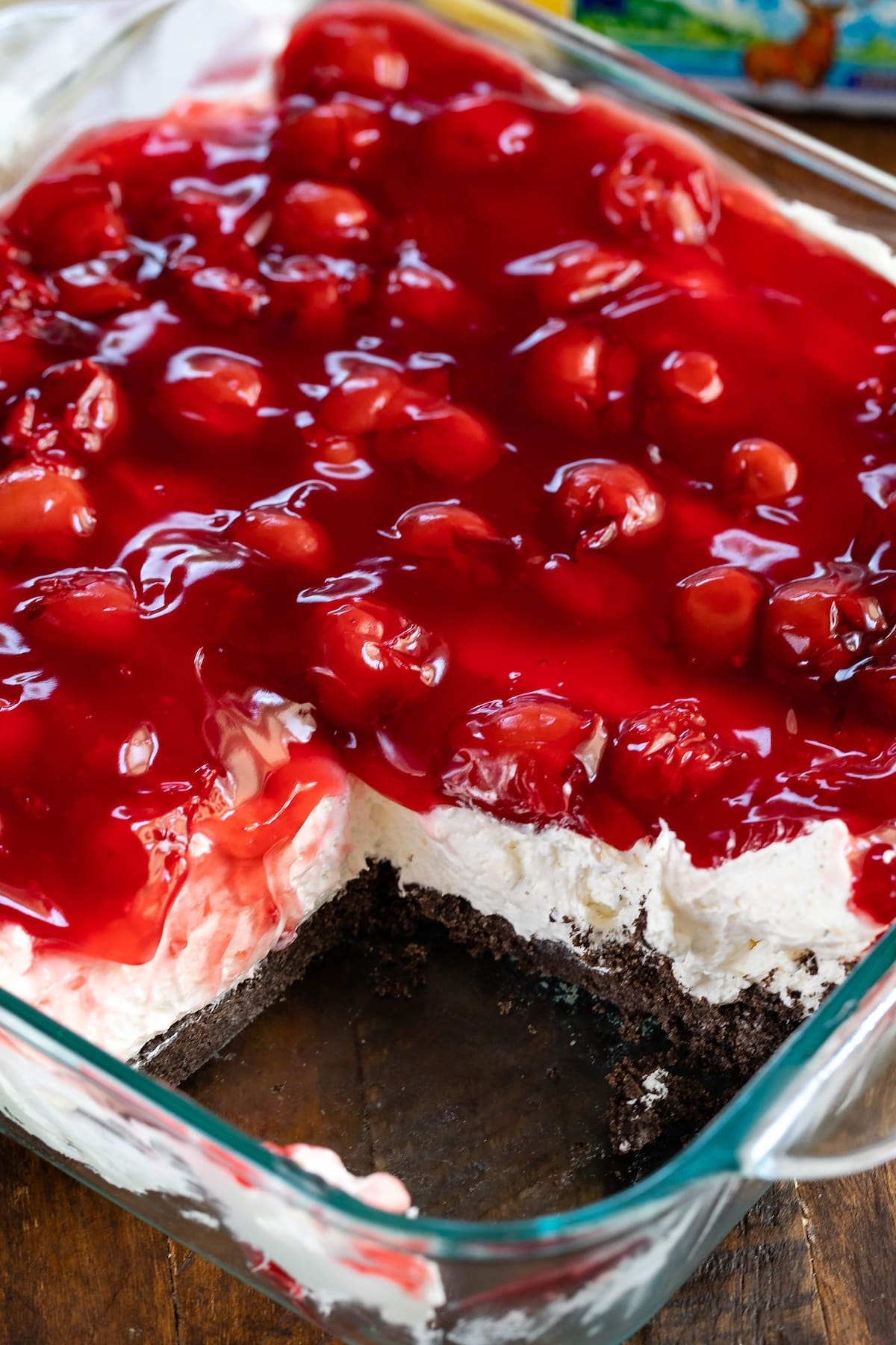 layered dessert topped with cherries.