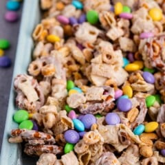 bunny munch mixed in a teal pan with white chocolate.