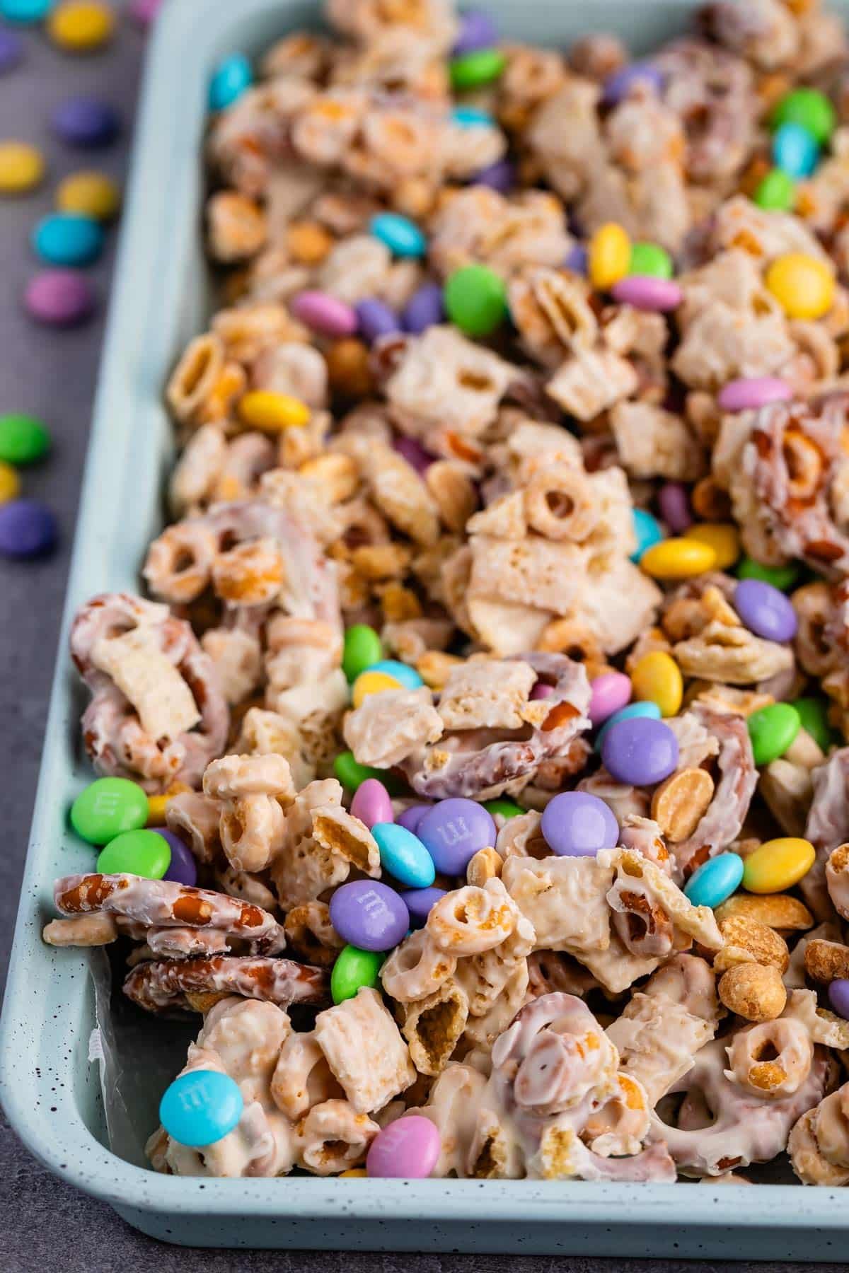 bunny munch mixed in a teal pan with white chocolate.