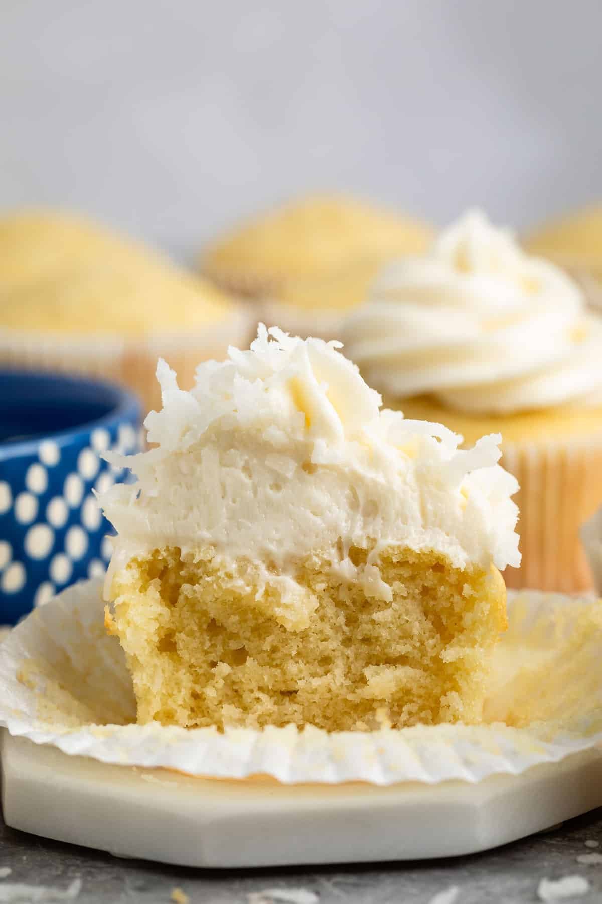 cupcakes with buttercream frosting and coconut shredded on top.