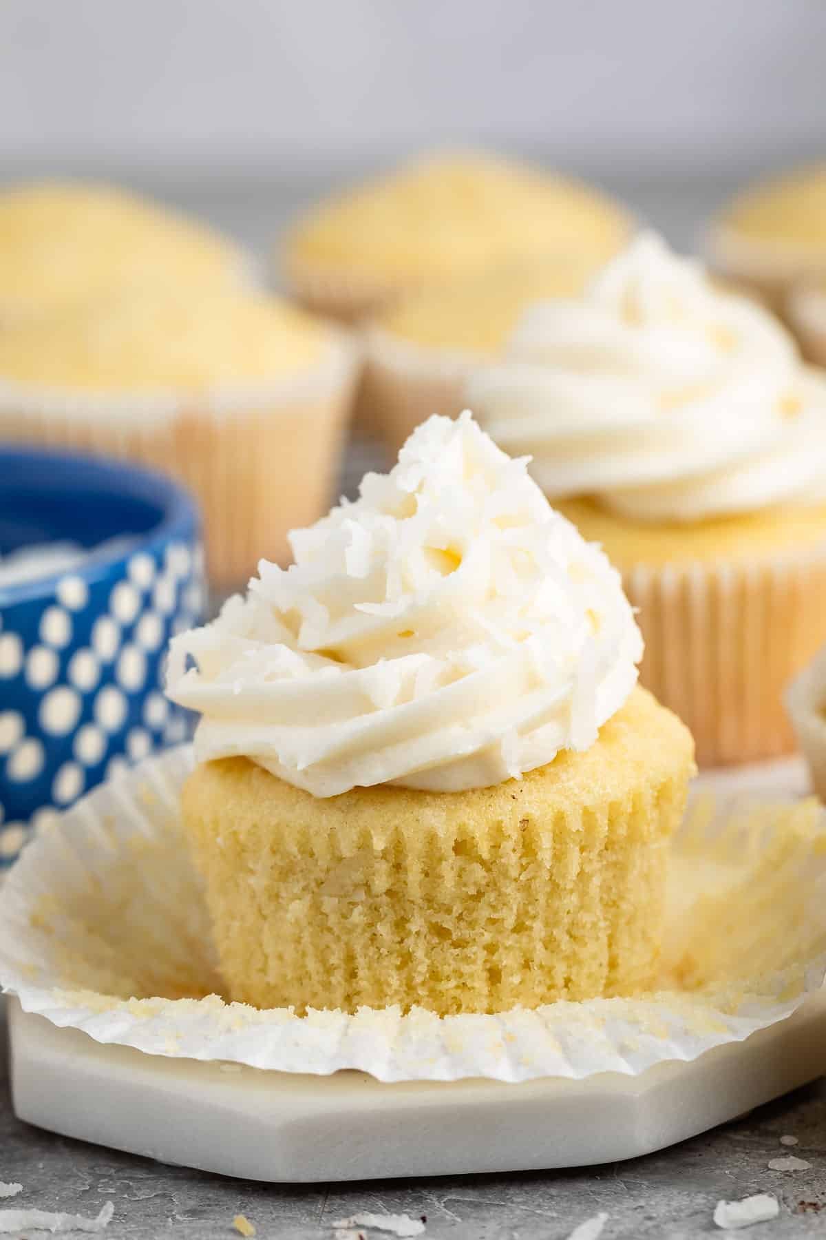 cupcakes with buttercream frosting and coconut shredded on top.