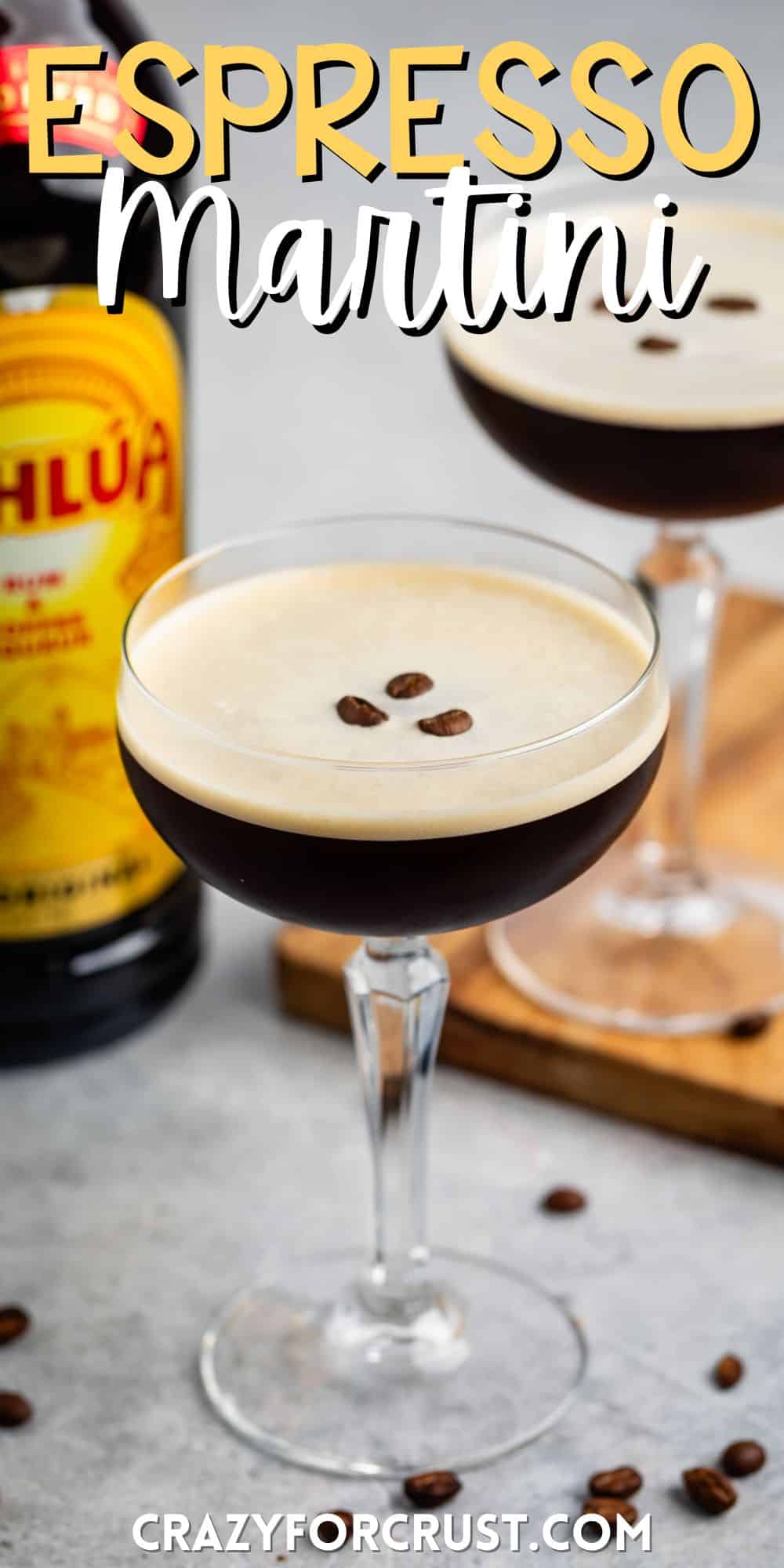 espresso martini in a tall clear glass with coffee beans all around the glass with words on the image.