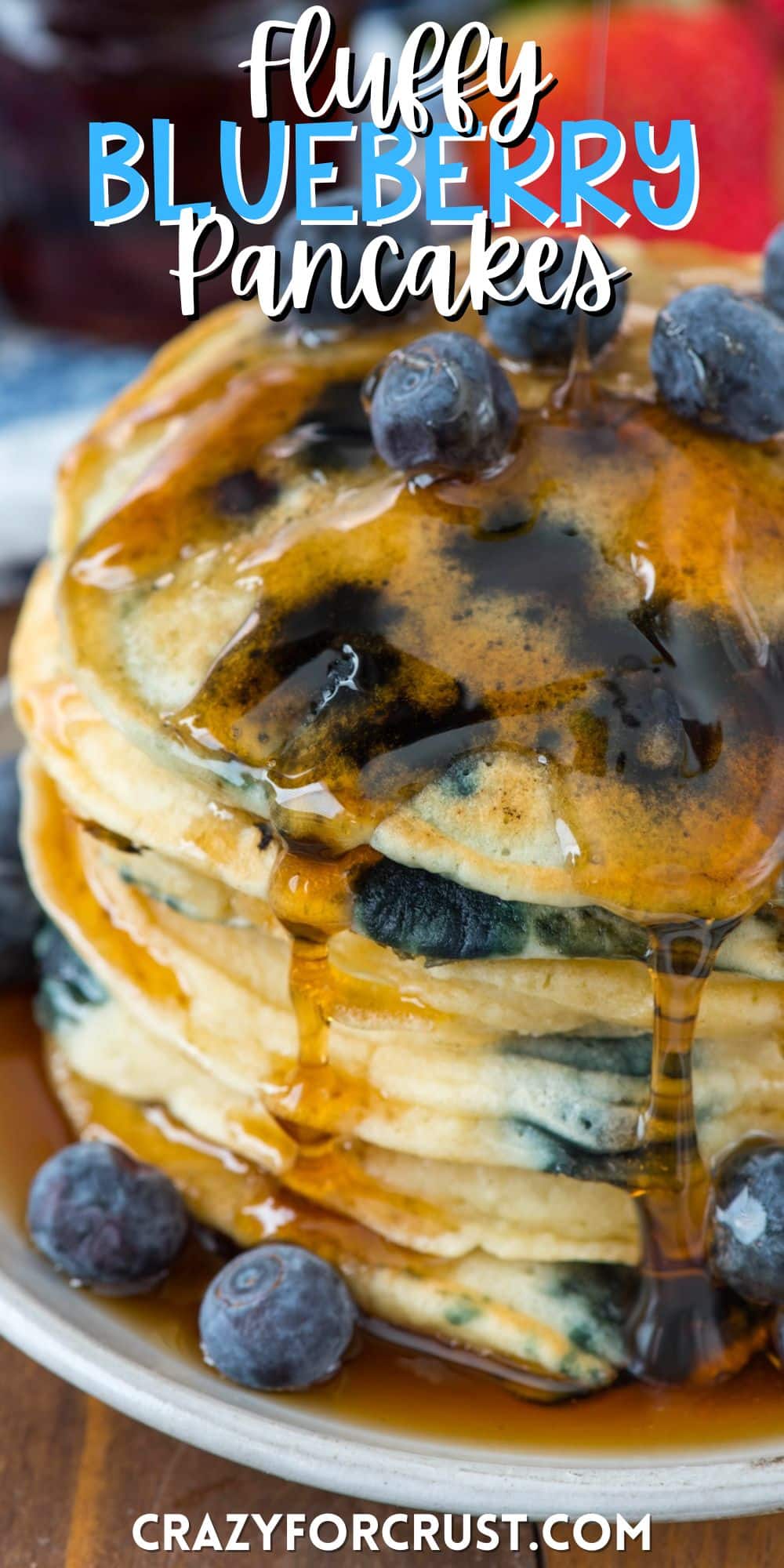 stacked pancakes with blueberries baked in and covered in syrup with words on the image.