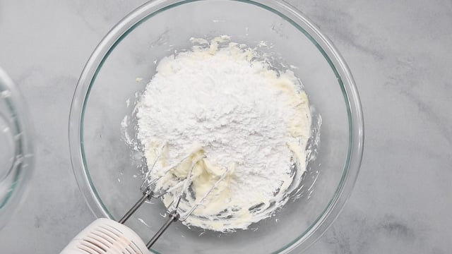 powdered sugar being added to frosting.