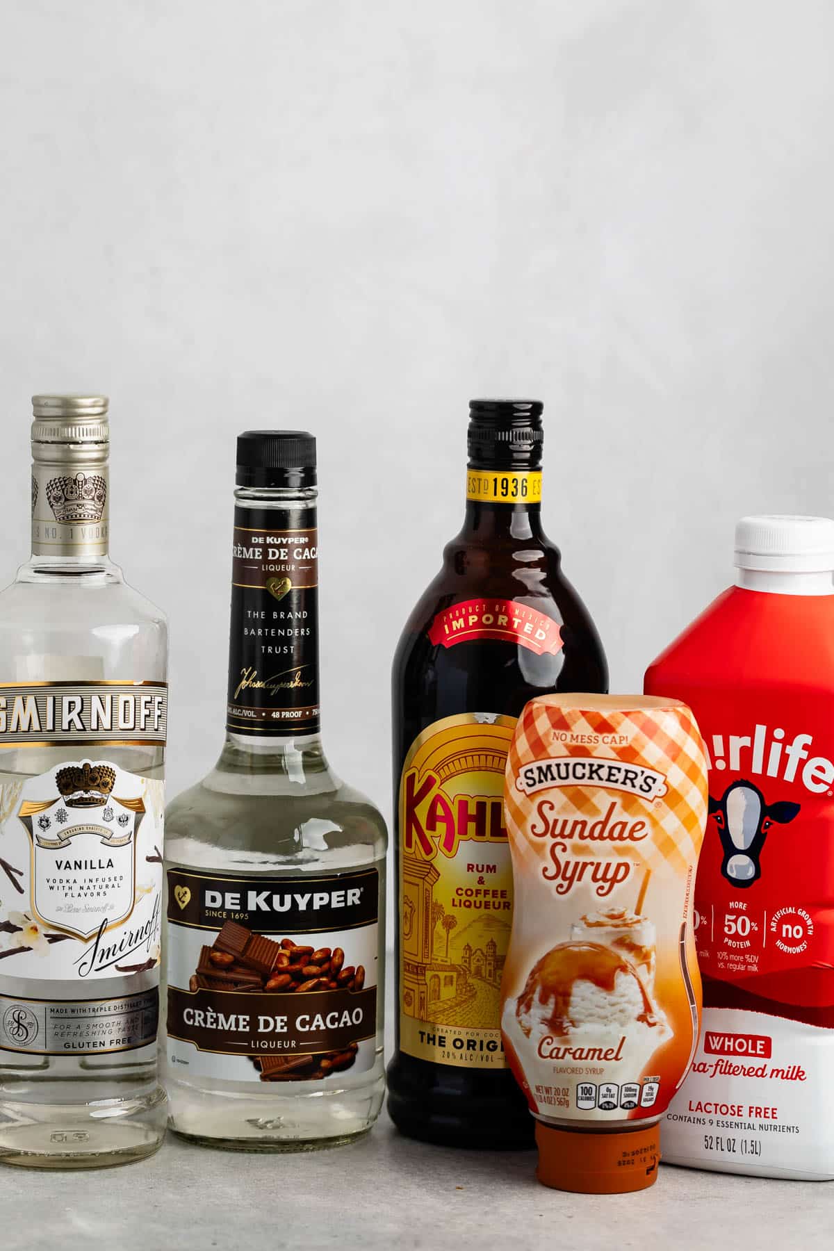 ingredients in salted caramel mocha martini laid out on a grey counter.