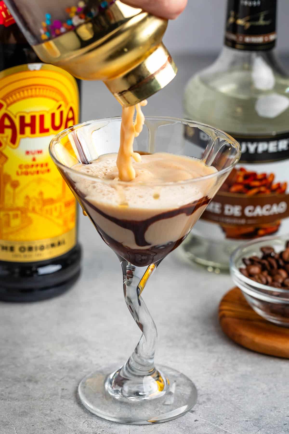 tall clear glass with chocolate and mocha martini inside.