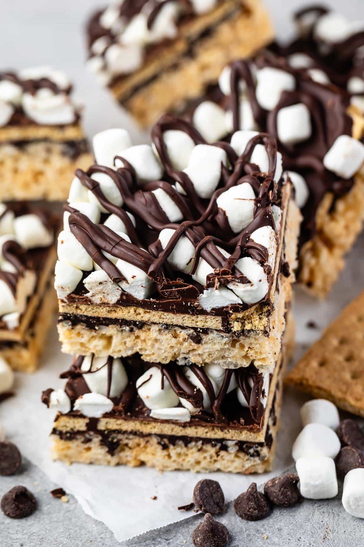 stacked Rice Krispie treats with marshmallows and chocolate on top.