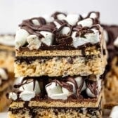 stacked Rice Krispie treats with marshmallows and chocolate on top.