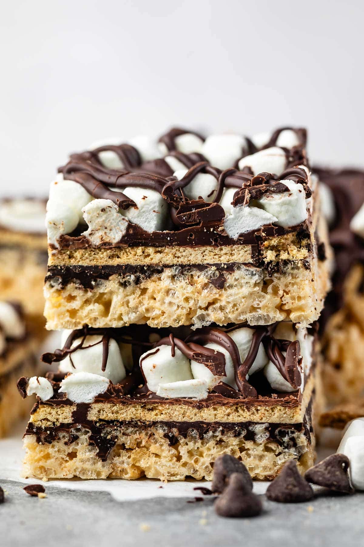 stacked Rice Krispie treats with marshmallows and chocolate on top.