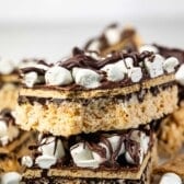 stacked Rice Krispie treats with marshmallows and chocolate on top.