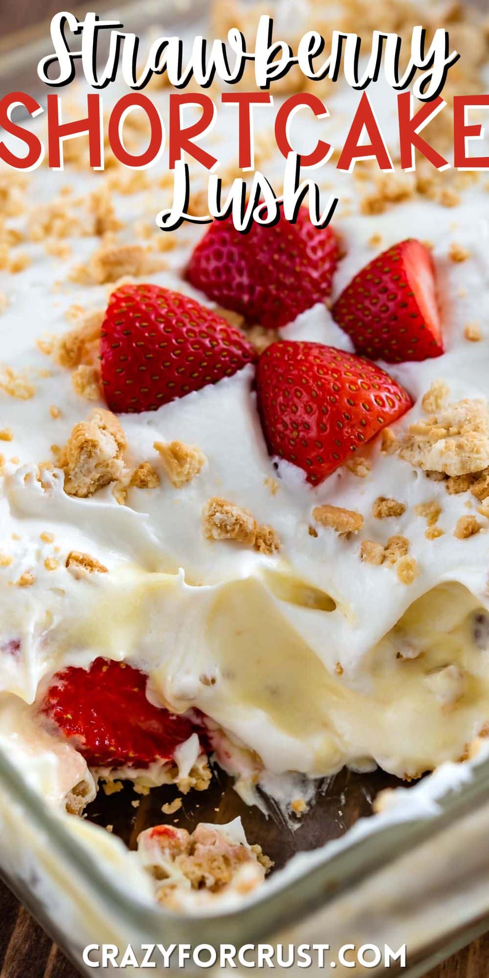 strawberry shortcake in a clear pan with sliced strawberries and crushed golden Oreos on top with words on the image.