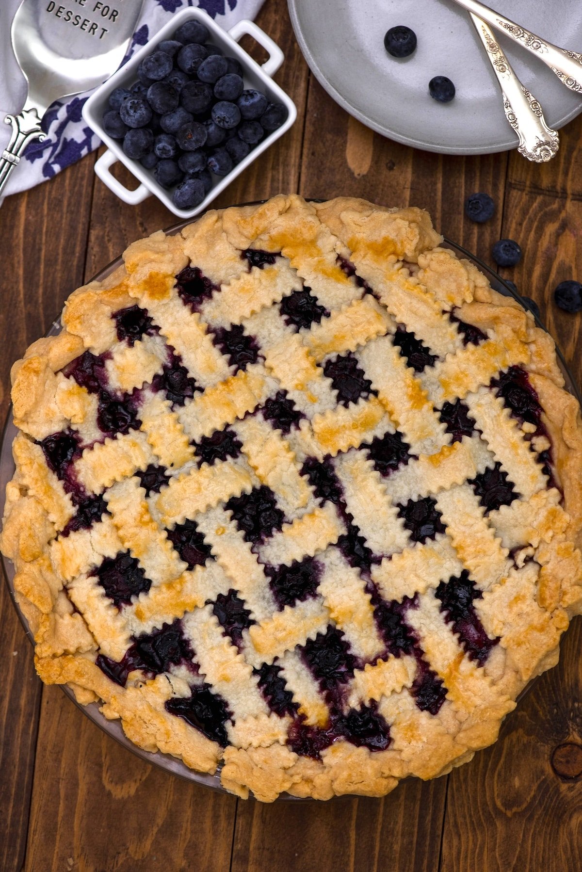 pie with blueberries baked in and with lattice design on top.