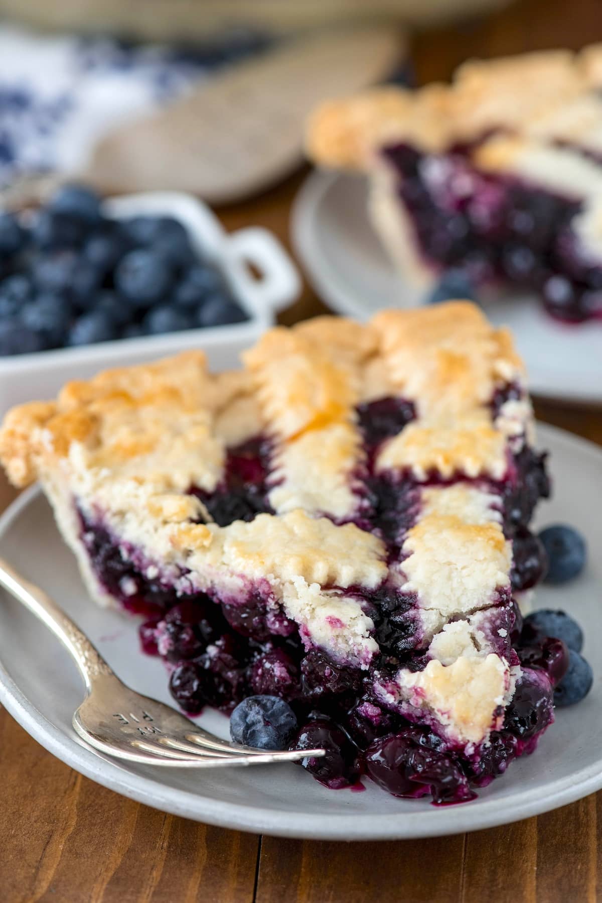 one slice of pie with blueberries baked in and with lattice design on top.