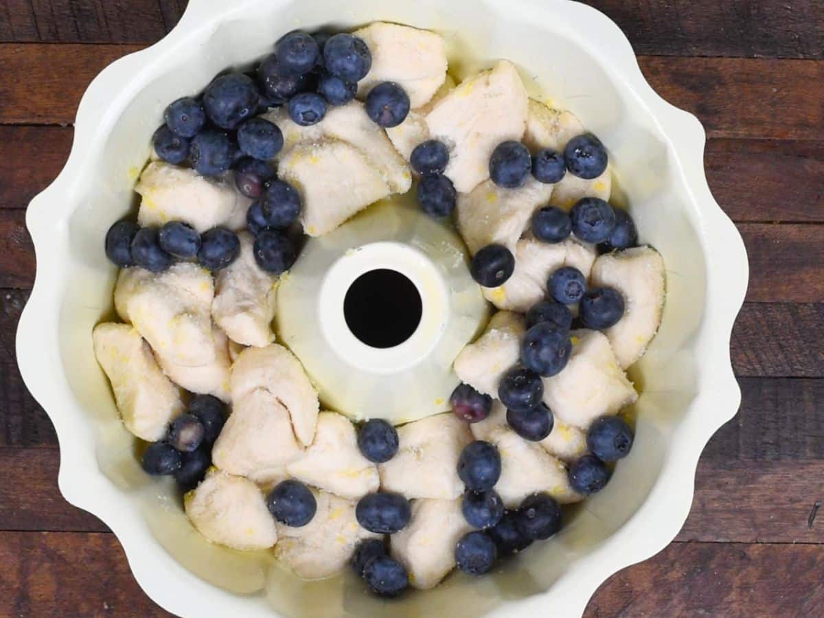 process shot of blueberry lemon monkey bread being made.