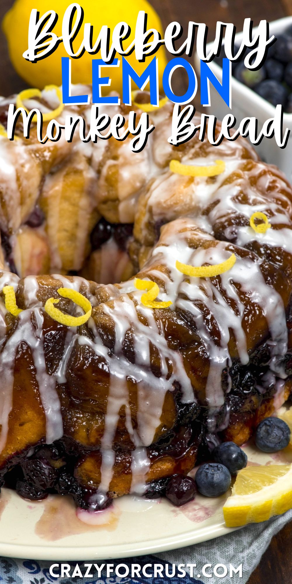 monkey bread covered in glaze and blueberries and lemon slices with words on the image.