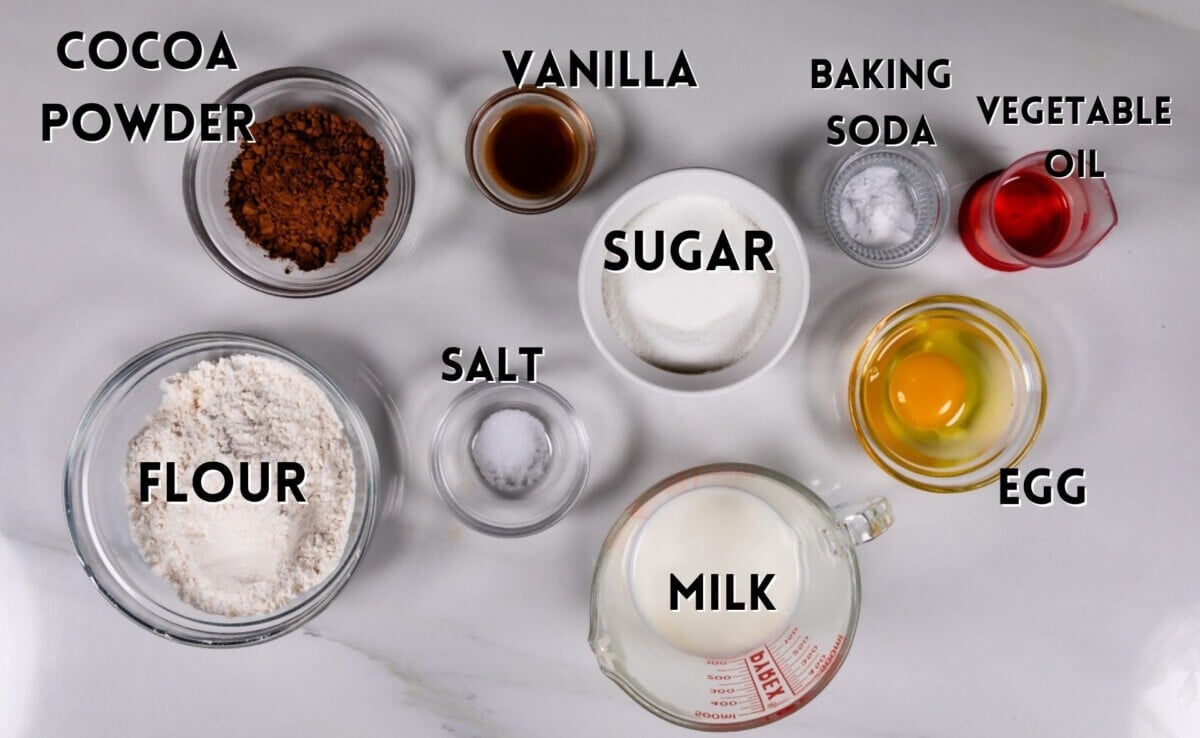 ingredients in chocolate donuts laid out on a white counter.