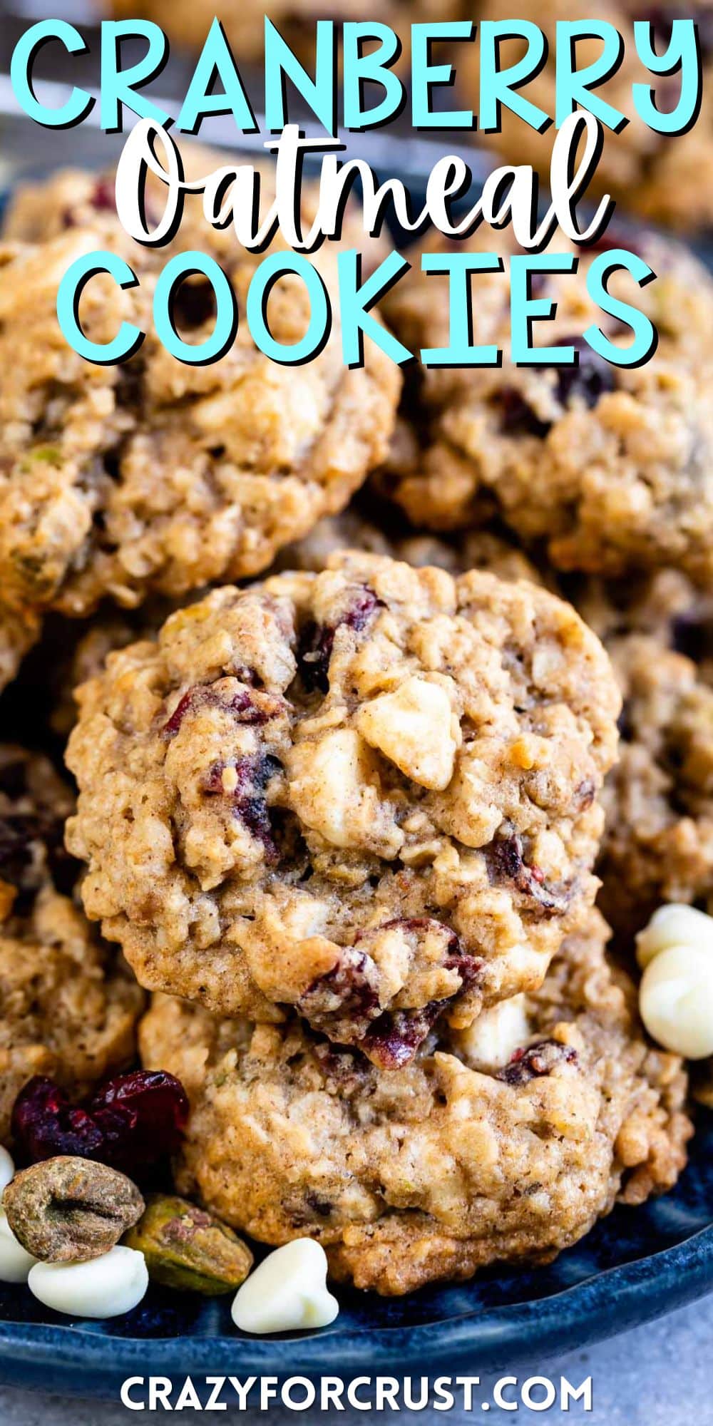 stacked cookies with white chocolate and cranberries baked in on a blue plate with words on the image.