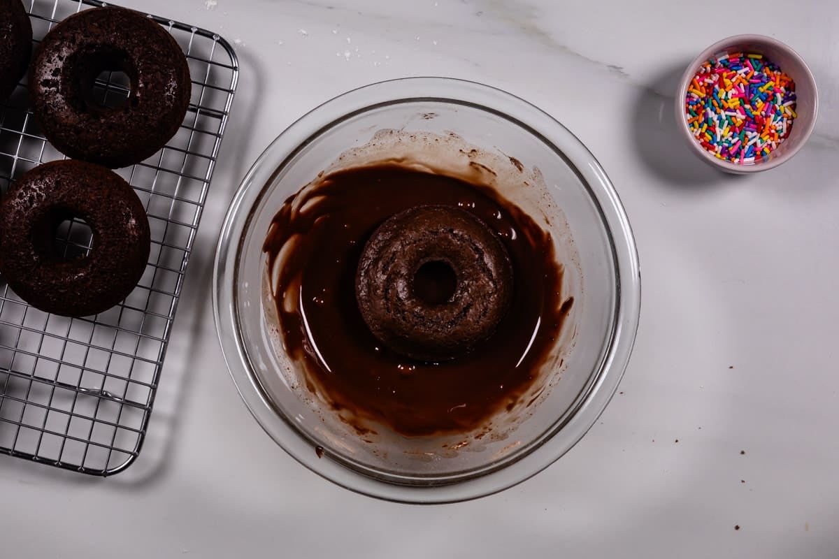 process shot of chocolate donuts being made.