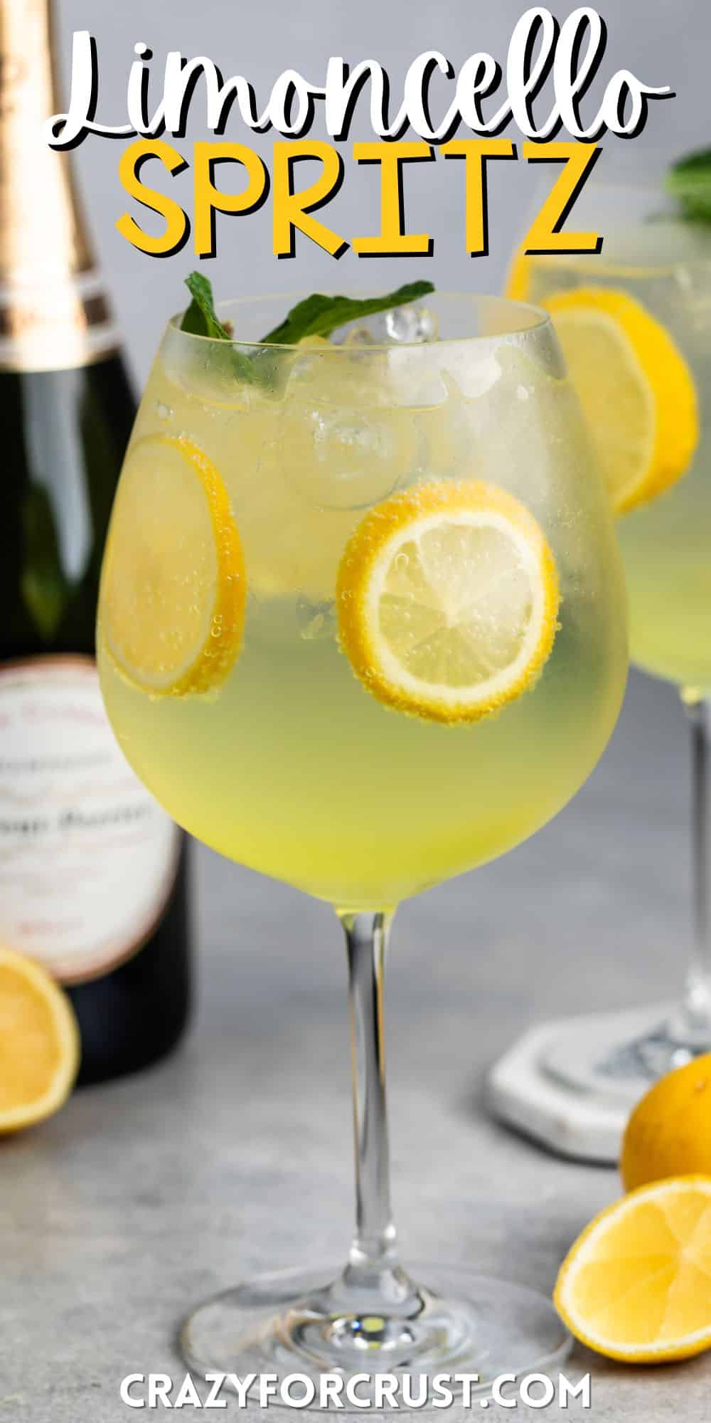 tall clear glass of yellow limoncello with sliced lemons throughout the drink with words on the image.