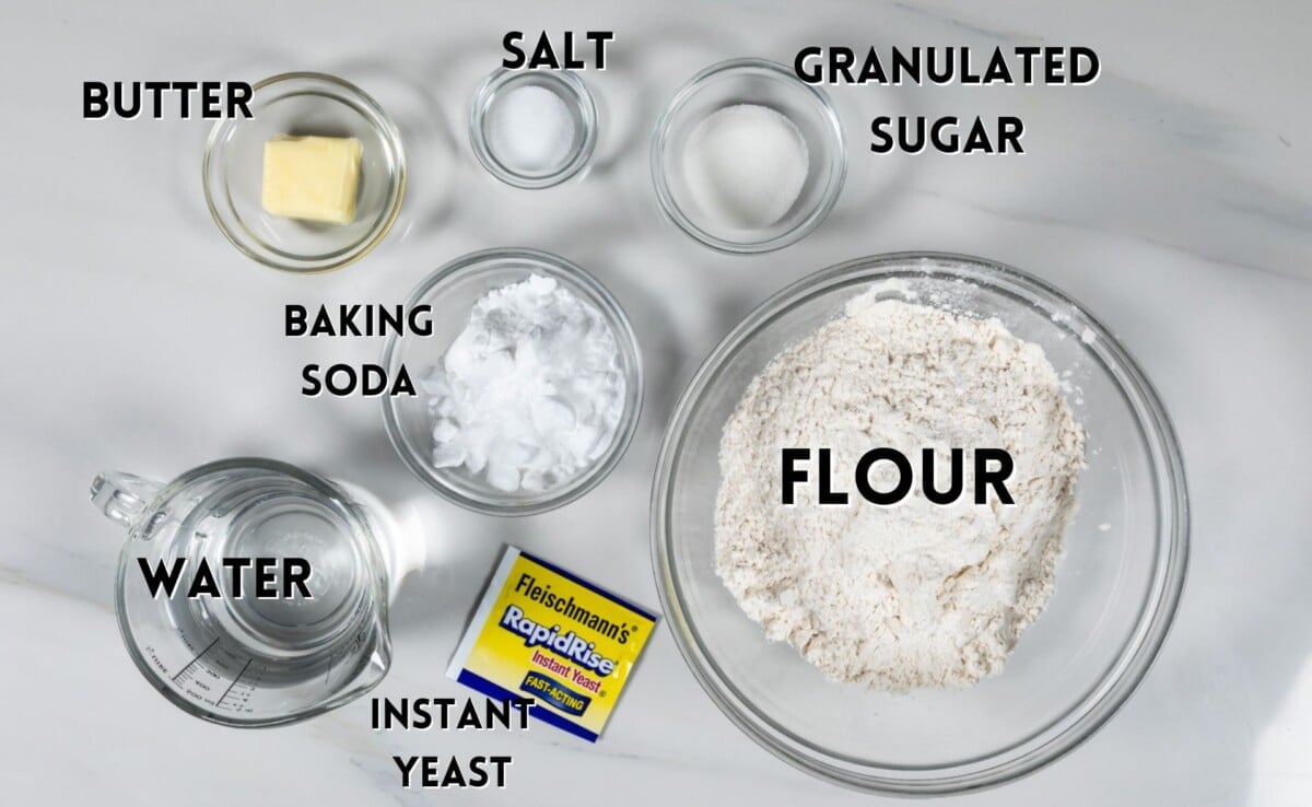 ingredients in soft pretzel recipe laid out on a white counter.