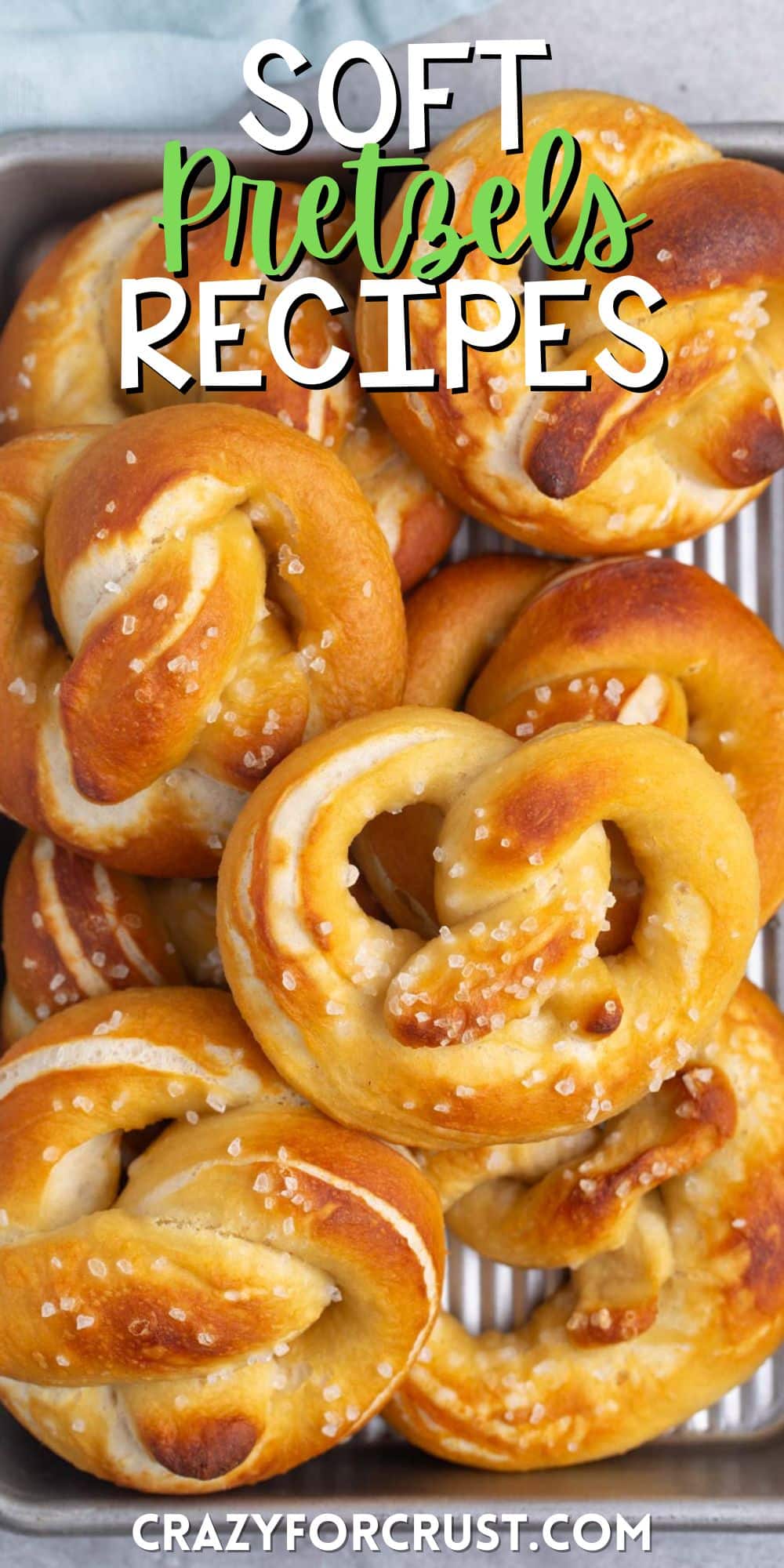 golden brown soft pretzels stacked with salt on top with words on the image.