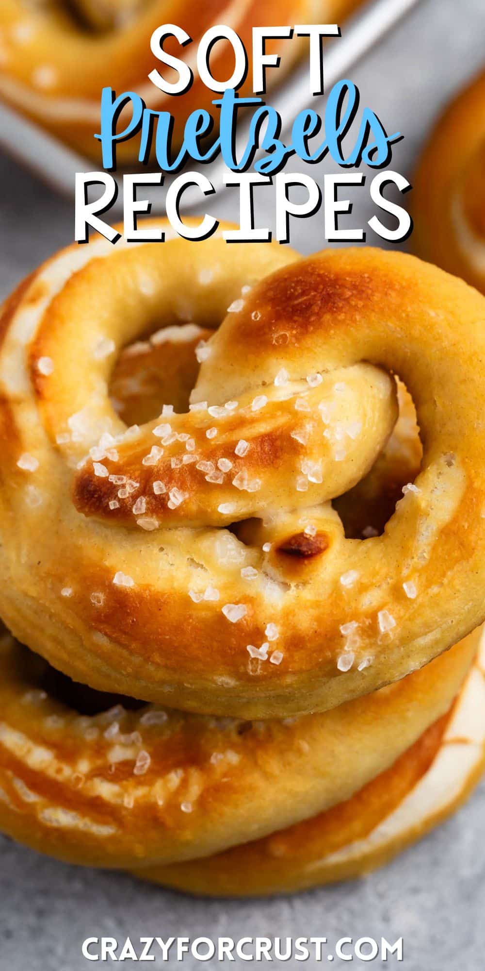 golden brown soft pretzels stacked with salt on top with words on the image.
